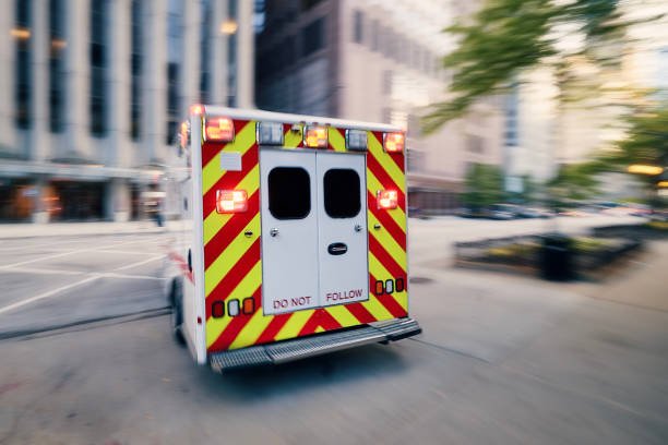 An ambulance rushes through a city street, highlighting its role in non-emergency medical transportation services.