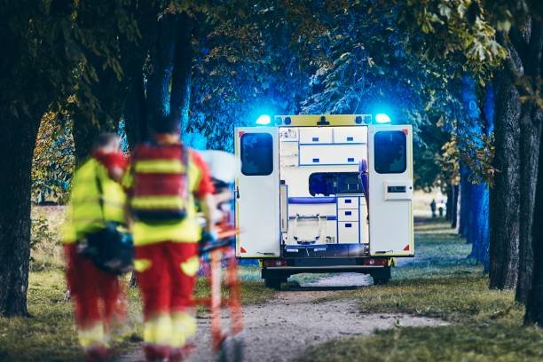 City street scene with an ambulance speeding by, representing non-emergency medical transportation in action.