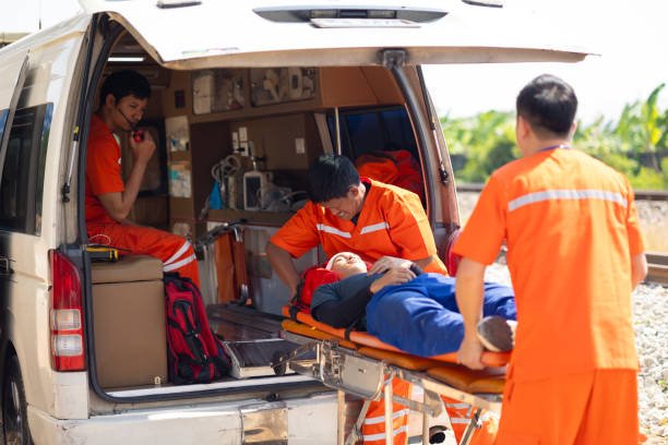 A doctor and nurse attend to a patient in an ambulance, highlighting the importance of rides to medical appointments.