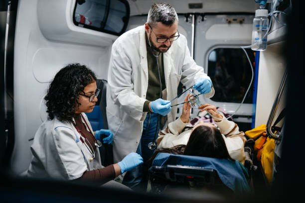  A doctor and nurse are treating a patient inside an ambulance, showcasing the critical service of rides to medical appointments.