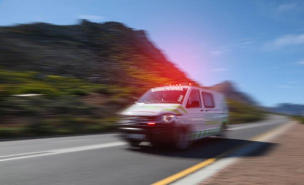 An ambulance traveling along the road, dedicated to rides to medical appointments.