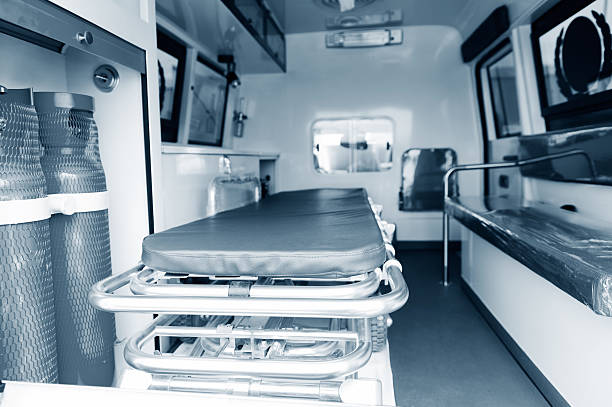 A person in blue gloves pushes a stretcher, representing Secure Med Transport's commitment to patient care.
