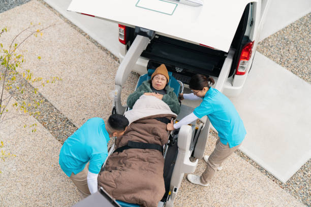 A wheelchair rests next to an ambulance, representing facilities for non-emergency medical transportation assistance.