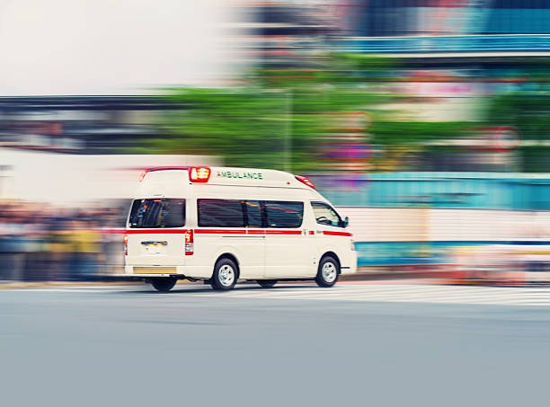 An ambulance driving on the road, symbolizing urgent medical transportation services.