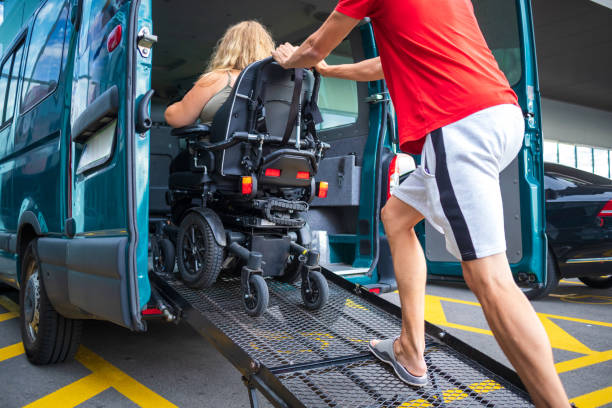 A man in a wheelchair occupies a seat at the back of a bus, showcasing accessible transportation services.