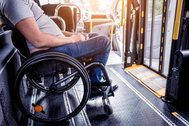 A man in a wheelchair seated at the back of a bus, highlighting accessible transportation options.